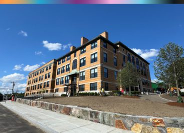 Photo showing The Pryde at Hyde Park in foreshortened perspective from the front entrance and walkway.