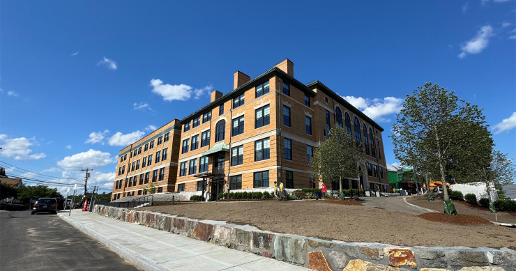 Photo showing The Pryde at Hyde Park in foreshortened perspective from the front entrance and walkway.